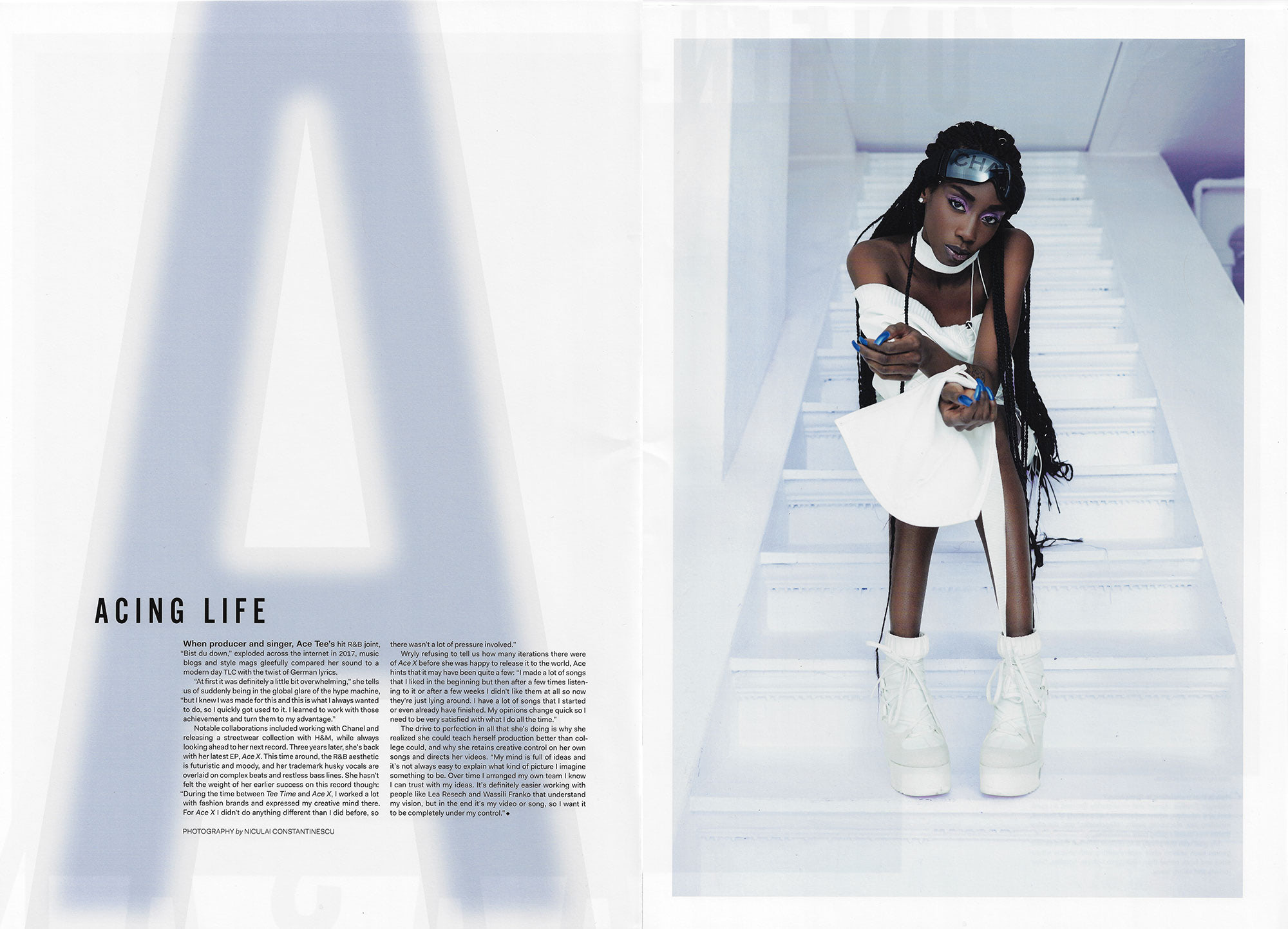 scan of interior spread with large icy A on the left and photograph of young black woman in a ahite outfit sitting on white stairs